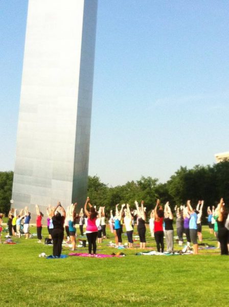 Visitors doing Yoga under the Gateway Arch