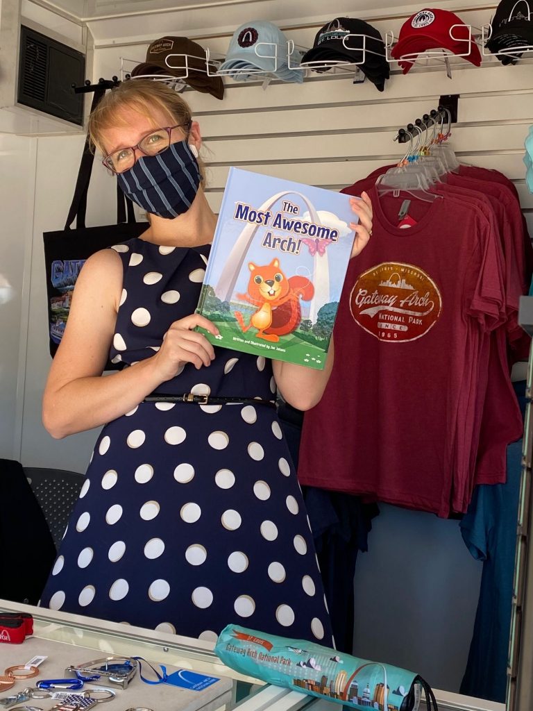 A store worker holding up "The Most Awesome Arch!" book.
