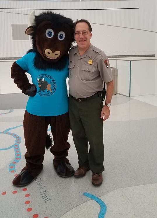 Man poses with bison mascot