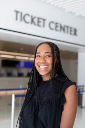 Female standing in front of the ticket center at the Arch