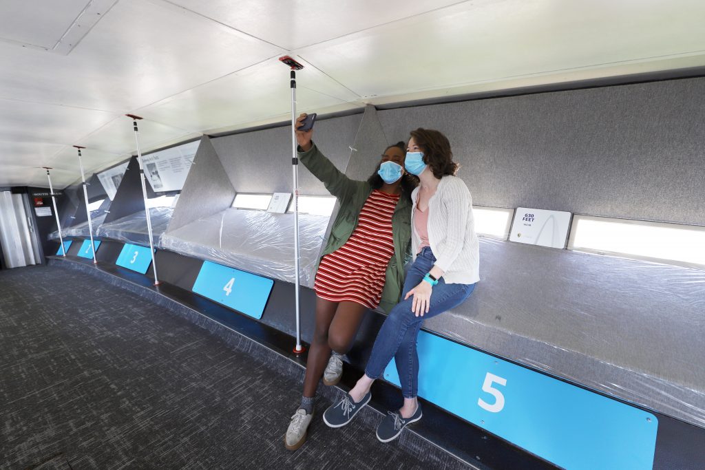 two young adult females taking a selfie at the top of the Arch