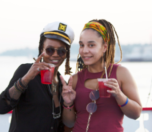 Two females on the riverboat holding a beverage