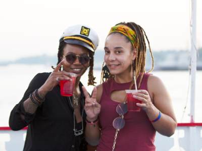 Two females on the riverboat holding a beverage