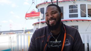 Tremmel Wilson is a Deckhand at the Riverboats at the Gateway Arch and is smiling while talking about his fun job