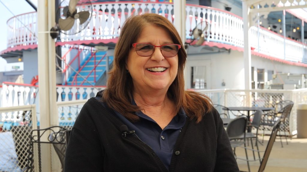 Gina Kabat, a cashier and server aboard the Riverboats at the Gateway Arch, smiles as she talks about her job