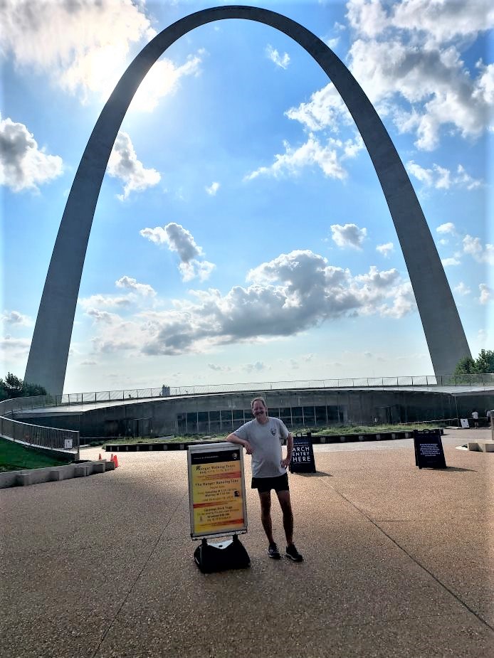 Ranger Frank of Gateway Arch National Park standing in front of the Arch one morning before beginning his running tour.