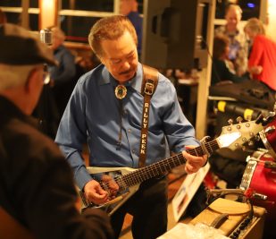 Artist Billy Peek strums his guitar while performing hit blues songs aboard a Blues Cruise on the Riverboats at the Gateway Arch.