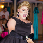 Diva accepts tip from guest aboard Decked Out Divas drag show on Riverboat.