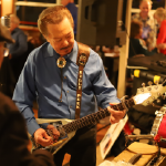Artist Billy Peek strums his guitar while performing hit blues songs aboard a Blues Cruise on the Riverboats at the Gateway Arch.