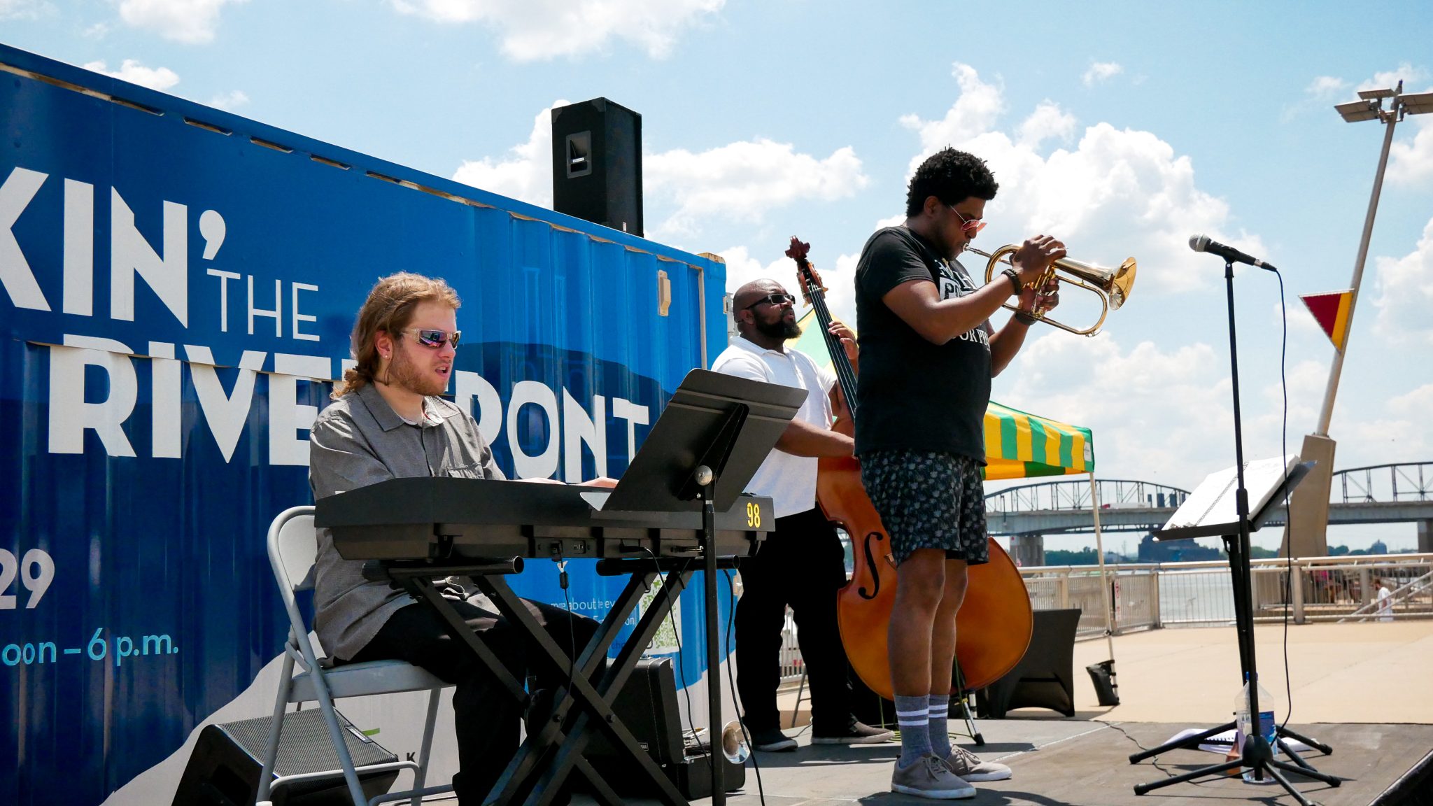 A three-piece band performs on a beautiful day on the St. Louis Riverfront during the Rockin' on the Riverfront event.