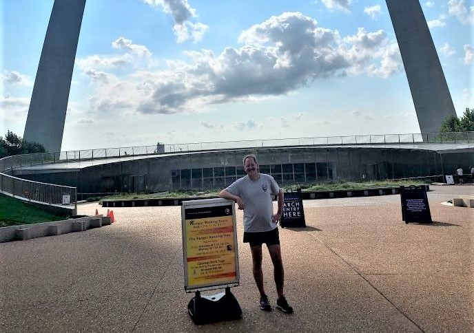 Ranger Frank of Gateway Arch National Park standing in front of the Arch one morning before beginning his running tour.