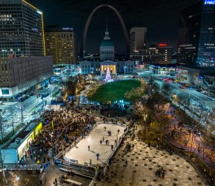 Aerial image of Kiener Plaza decorated for Winterfest at night. Provided by Gateway Arch Park Foundation.