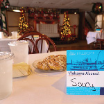 A placemat is set on a table with drinks, silverware and cinnamon rolls before a cruise on the Riverboats at the Gateway Arch.
