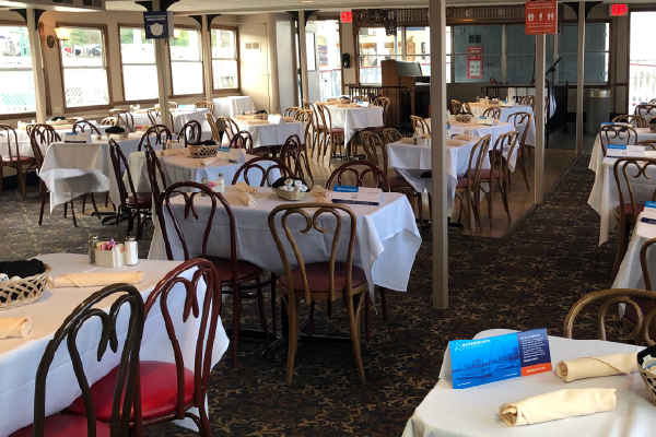 tables set up for a Dinner Cruise on a riverboat
