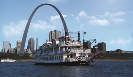 The Tom Sawyer Riverboat cruises the Mississippi River in front of the Gateway Arch and St. Louis skyline