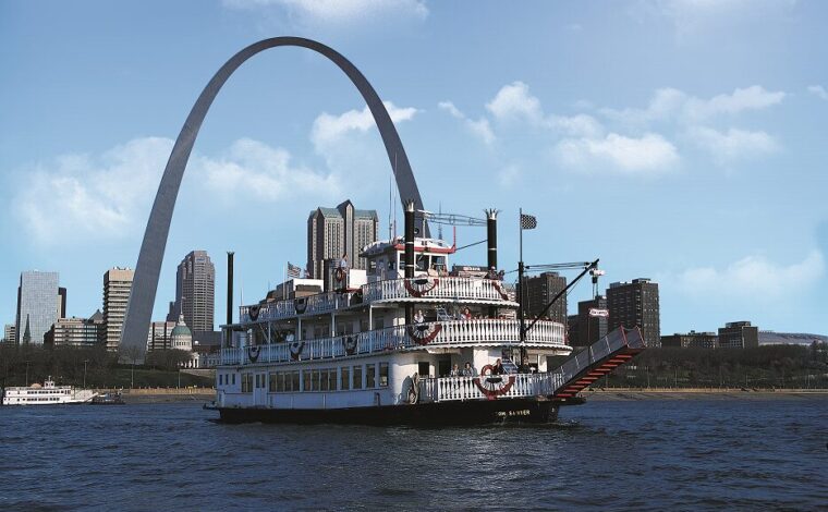 The Tom Sawyer Riverboat cruises the Mississippi River in front of the Gateway Arch and St. Louis skyline