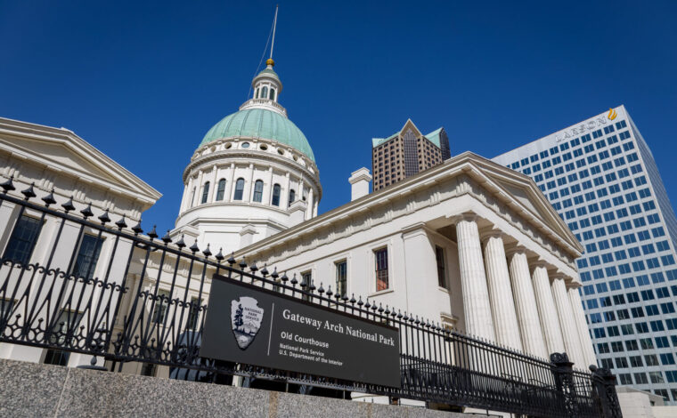 Low angle picture of the Old Courthouse at Gateway Arch National Park with a blue sky behind it