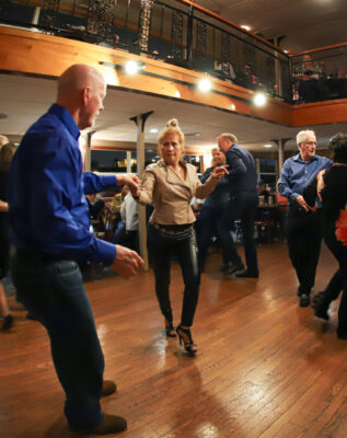 Sets of couples dance to live music during a Blues Cruise on the Riverboats at the Gateway Arch