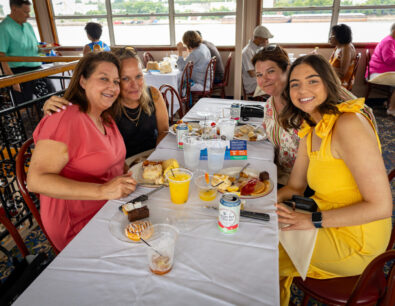Group of four females sitting at a table onboard the Tom Sawyer riverboat enjoying brunch.