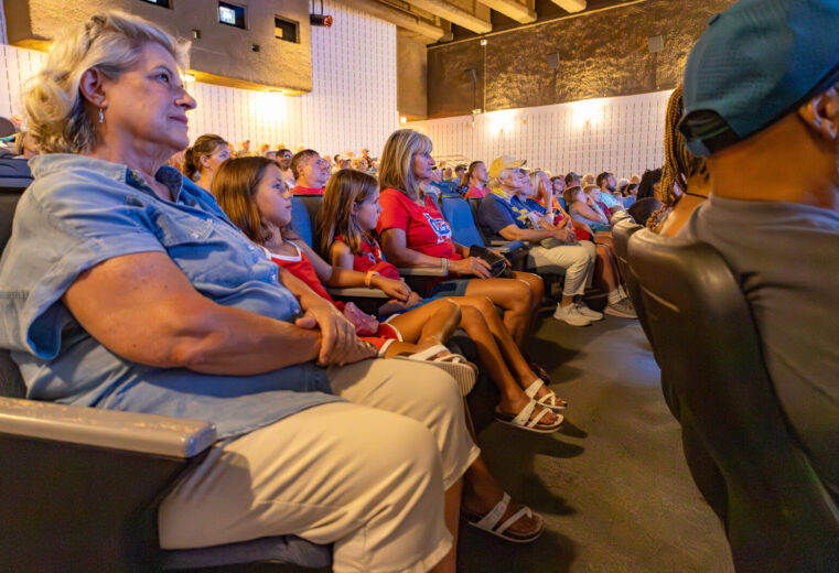People sitting inside Tucker Theater watching a documentary