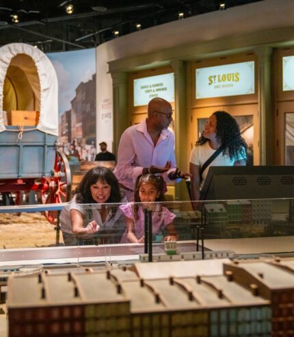 Family explores the museum under the Gateway Arch in the Riverfront Era Gallery