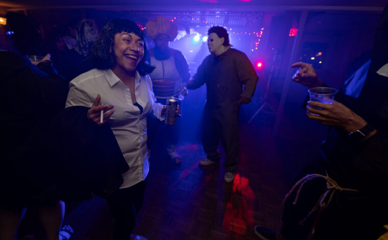 People in Halloween costumes dance to a DJ during the Halloween Costume Cruise on the Riverboats at the Gateway Arch.