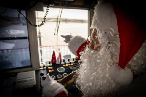 Santa at the helm of the Riverboats at the Gateway Arch to tease The Floating Sleigh is coming to town