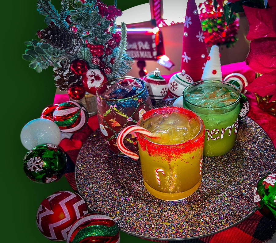 Three holiday drinks displayed on a festive table against a green background.
