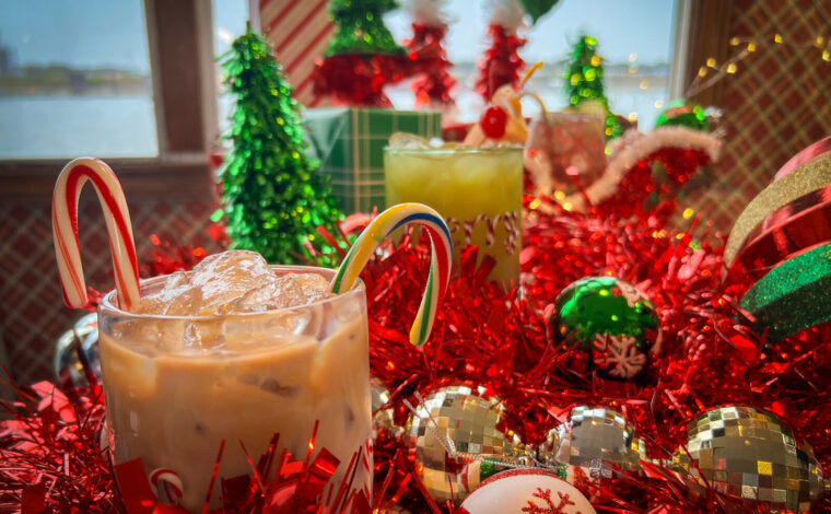 Holiday drinks from The Floating Sleigh pop-up bar displayed on with Christmas decor everywhere on the Tom Sawyer Riverboat