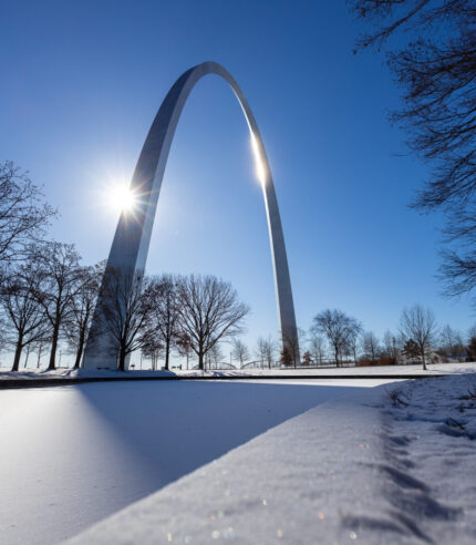 snow covered ground with the Gateway Arch in the background