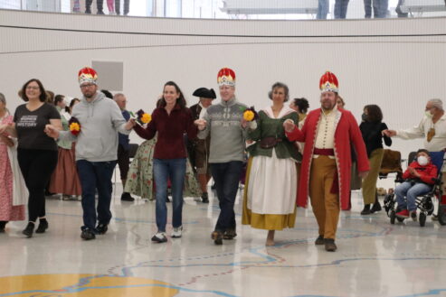 Living history performers dressed in 1770s attire perform dances popular in St. Louis in the 1770s inside the Gateway Arch Visitor Center