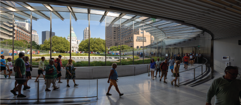 People walking into the Gateway Arch visitor center.
