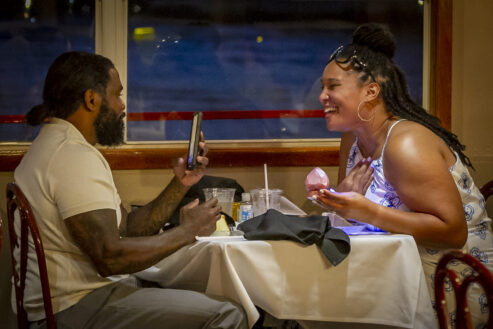 A couple laughs during dinner aboard the Tom Sawyer riverboat during a Skyline Dinner Cruise