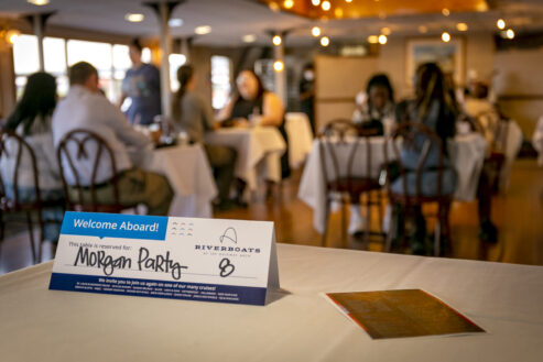Table tent on a dinner table aboard the Tom Sawyer riverboat during a Skyline Dinner Cruise