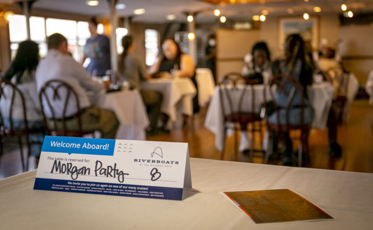 Table tent on a dinner table aboard the Tom Sawyer riverboat during a Skyline Dinner Cruise