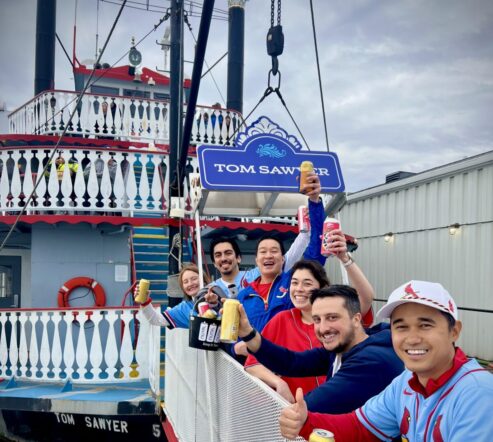 St. Louis Cardinals fans cheers as they board a cruise on the Tom Sawyer Riverboat