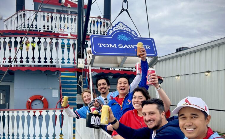 St. Louis Cardinals fans cheers as they board a cruise on the Tom Sawyer Riverboat